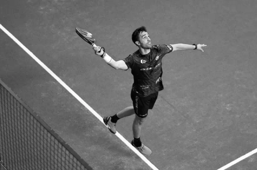 Padel player Sergio Alba performing a bandeja shot during a match, focusing on control and placement.