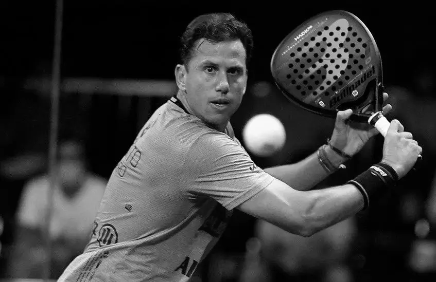 Paquito Navarro locked in, showcasing his signature backhand technique during a high-stakes padel match.